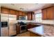 Kitchen boasts stainless steel appliances and wood cabinets at 1777 S Balboa Dr, Gilbert, AZ 85295