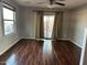 Living room with dark hardwood floors and sliding glass doors at 1777 S Balboa Dr, Gilbert, AZ 85295