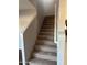 Carpeted staircase with neutral-colored walls and white railing at 1777 S Balboa Dr, Gilbert, AZ 85295