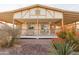 Charming house with a large front porch and well-maintained landscaping at 180 S Stardust Ln, Apache Junction, AZ 85120