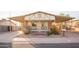 Charming house exterior with covered porch and landscaping at 180 S Stardust Ln, Apache Junction, AZ 85120