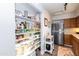 Well-equipped kitchen featuring wood cabinets and a pantry at 180 S Stardust Ln, Apache Junction, AZ 85120