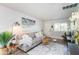 Open living area with gray sofa and entryway at 180 S Stardust Ln, Apache Junction, AZ 85120