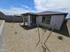 Landscaped backyard with a covered patio at 18182 W Poston Dr, Surprise, AZ 85387