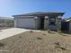 Single-story home with stone accents and a two-car garage at 18182 W Poston Dr, Surprise, AZ 85387