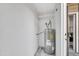 Small laundry room with water heater and shelving at 18621 N 34Th Ave # 1, Phoenix, AZ 85027