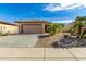 One-story house with desert landscaping and a two-car garage at 18727 N Desert Light Dr, Surprise, AZ 85387