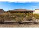 Backyard view of home with covered patio and pool at 18727 N Desert Light Dr, Surprise, AZ 85387