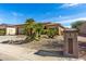 House with palm trees and a two-car garage at 18727 N Desert Light Dr, Surprise, AZ 85387