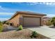 Tan house with a two-car garage and side yard at 18727 N Desert Light Dr, Surprise, AZ 85387