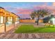 Charming backyard with pergola, artificial turf, and string lights at 1921 W Monte Vista Rd, Phoenix, AZ 85009