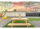 Backyard with picnic table, games, and yellow chair at 1921 W Monte Vista Rd, Phoenix, AZ 85009