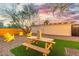 Relaxing backyard with picnic table, games, and yellow chairs at 1921 W Monte Vista Rd, Phoenix, AZ 85009