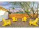 Relaxing backyard with yellow chairs and gravel ground at 1921 W Monte Vista Rd, Phoenix, AZ 85009