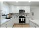 Clean kitchen with white cabinets, marble counters, and stainless steel appliances at 1921 W Monte Vista Rd, Phoenix, AZ 85009