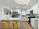 Bright kitchen features a breakfast bar with yellow stools and white shaker cabinets at 1921 W Monte Vista Rd, Phoenix, AZ 85009