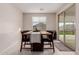 Bright dining area featuring wood table and chairs, with a sliding glass door to the backyard at 1983 E Sarona Ct, San Tan Valley, AZ 85143