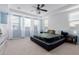 Main bedroom boasts tray ceilings, plush carpet, natural light, and a ceiling fan at 1983 E Sarona Ct, San Tan Valley, AZ 85143