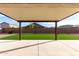 Covered patio features sleek concrete flooring and artificial grass, offering a cozy outdoor space at 1983 E Sarona Ct, San Tan Valley, AZ 85143