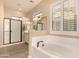 Elegant bathroom with soaking tub, walk-in shower, and double vanity at 2049 N 88Th St, Mesa, AZ 85207