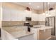 Modern kitchen with white cabinets, granite countertops, and stainless steel appliances at 2049 N 88Th St, Mesa, AZ 85207