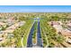 Aerial view of community with palm tree-lined streets and homes at 20767 N Bustos Way, Maricopa, AZ 85138