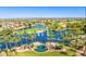 Aerial view of community with lake, fountains, golf course, and palm trees at 20767 N Bustos Way, Maricopa, AZ 85138