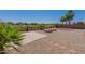 Landscaped backyard with fire pit and desert plants at 20767 N Bustos Way, Maricopa, AZ 85138