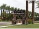 Rancho El Dorado community entrance with stone arch and palm trees at 20767 N Bustos Way, Maricopa, AZ 85138