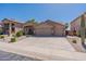 Three-car garage and nicely landscaped front yard highlight this home at 20767 N Bustos Way, Maricopa, AZ 85138