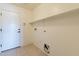 Laundry room with built-in shelving and exterior access at 20767 N Bustos Way, Maricopa, AZ 85138