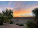 Sunset view over a desert landscape with retaining wall at 20876 N Canyon Whisper Dr, Surprise, AZ 85387