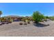 Landscaped backyard with gravel, offering privacy and seclusion at 20876 N Canyon Whisper Dr, Surprise, AZ 85387