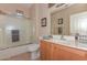 Clean bathroom with shower/tub combo, wood vanity, and updated fixtures at 20876 N Canyon Whisper Dr, Surprise, AZ 85387