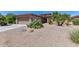 Single story home with desert landscaping and two-car garage at 20876 N Canyon Whisper Dr, Surprise, AZ 85387