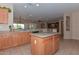 Kitchen with island and view into living and dining areas at 20876 N Canyon Whisper Dr, Surprise, AZ 85387