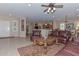 Spacious living room with leather furniture and tiled floors at 20876 N Canyon Whisper Dr, Surprise, AZ 85387