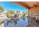 Covered patio with seating area, perfect for outdoor dining at 20876 N Canyon Whisper Dr, Surprise, AZ 85387