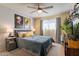 Guest bedroom with dark blue quilted coverlet and ceiling fan at 21 W Del Rio Dr, Tempe, AZ 85282