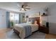 Cozy bedroom with wood bed frame, hanging planter, and ceiling fan at 21 W Del Rio Dr, Tempe, AZ 85282