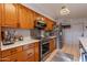 Well-equipped kitchen with stainless steel appliances and wood cabinets at 21 W Del Rio Dr, Tempe, AZ 85282