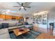 Living room with L-shaped sofa, wood floors, and built-in bookcase at 21 W Del Rio Dr, Tempe, AZ 85282