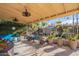 Covered patio with seating area, lush landscaping, and great backyard views at 21 W Del Rio Dr, Tempe, AZ 85282