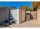 White metal storage shed with a garden cart at 21 W Del Rio Dr, Tempe, AZ 85282