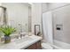 Clean bathroom with a single vanity, shower/tub combo, and neutral tones at 23491 N 125Th Pl, Scottsdale, AZ 85255