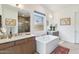 Spa-like bathroom with double vanity, soaking tub, and walk-in shower at 23491 N 125Th Pl, Scottsdale, AZ 85255