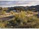 Wide shot of a modern estate with natural desert landscape and distant mountain views, perfect for luxury living at 23491 N 125Th Pl, Scottsdale, AZ 85255