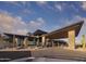 Striking building with stone accents, modern roofline, and desert landscaping under a bright blue sky at 23491 N 125Th Pl, Scottsdale, AZ 85255