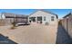 Back exterior view of home featuring a trampoline, gravel yard, and covered patio at 24134 N Cotton Cir, Florence, AZ 85132