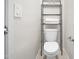 Bathroom featuring a toilet and a metal shelving unit for storing towels at 24134 N Cotton Cir, Florence, AZ 85132